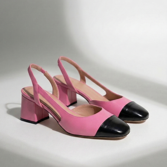 Pink and black shoes on a light gray background