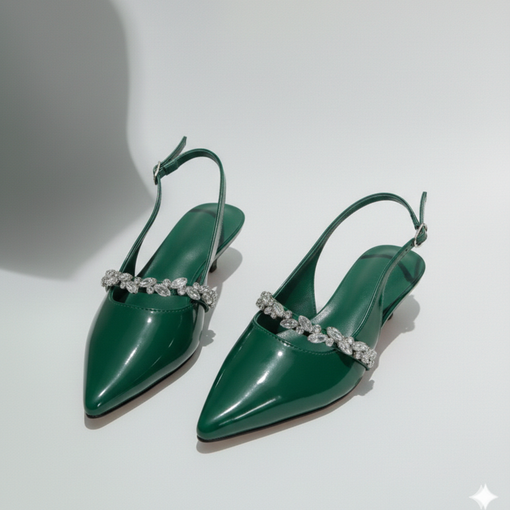 Pair of green high-heeled shoes with decorative straps on a white background
