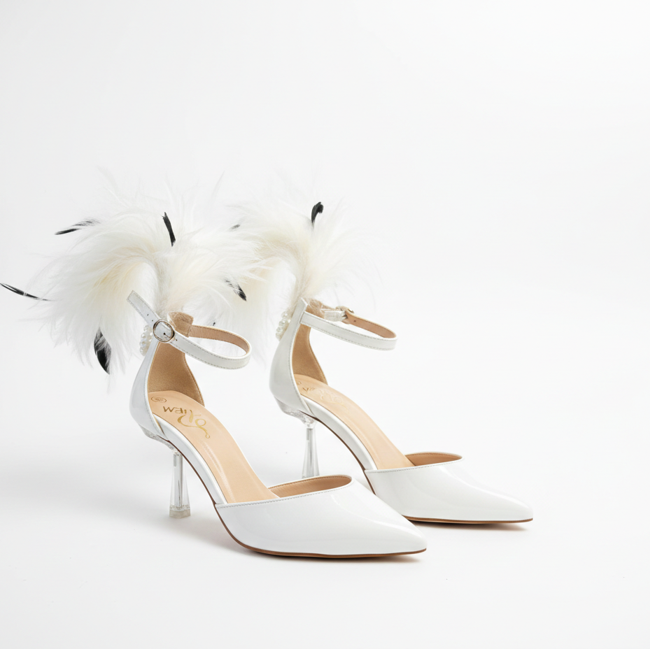 White high-heeled shoes with feather details on a light gray background