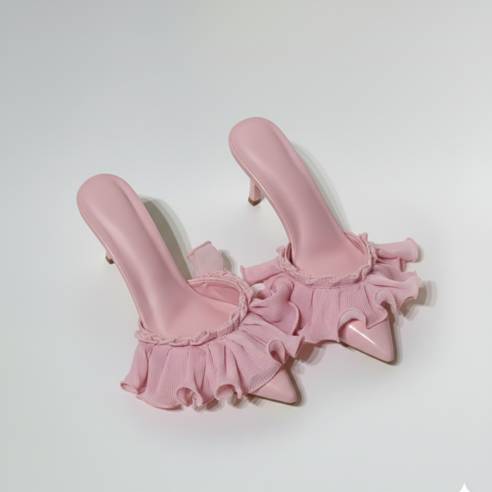 Pair of pink high-heeled shoes with ruffled details on a white background