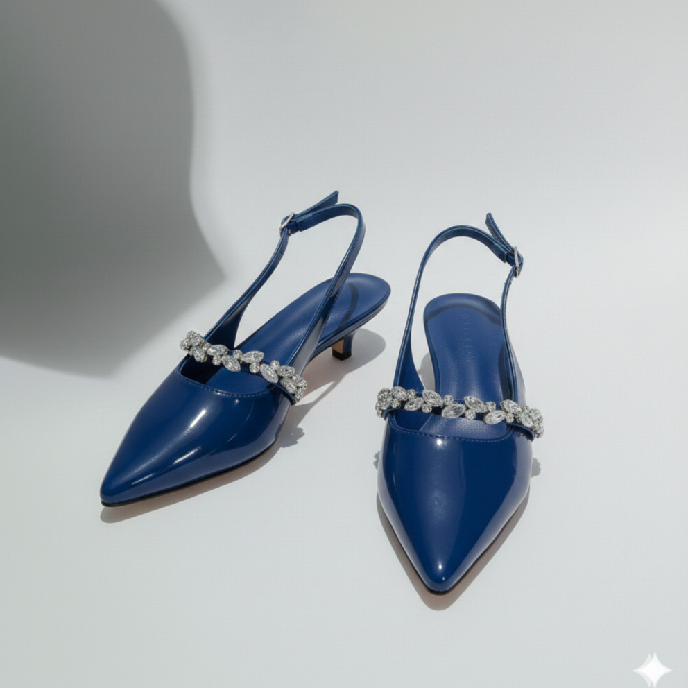 Pair of blue high-heeled shoes with decorative straps on a white background