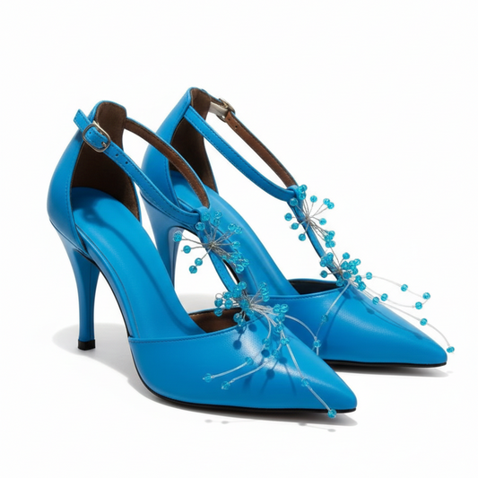 Blue high-heeled shoes with decorative elements on a white background