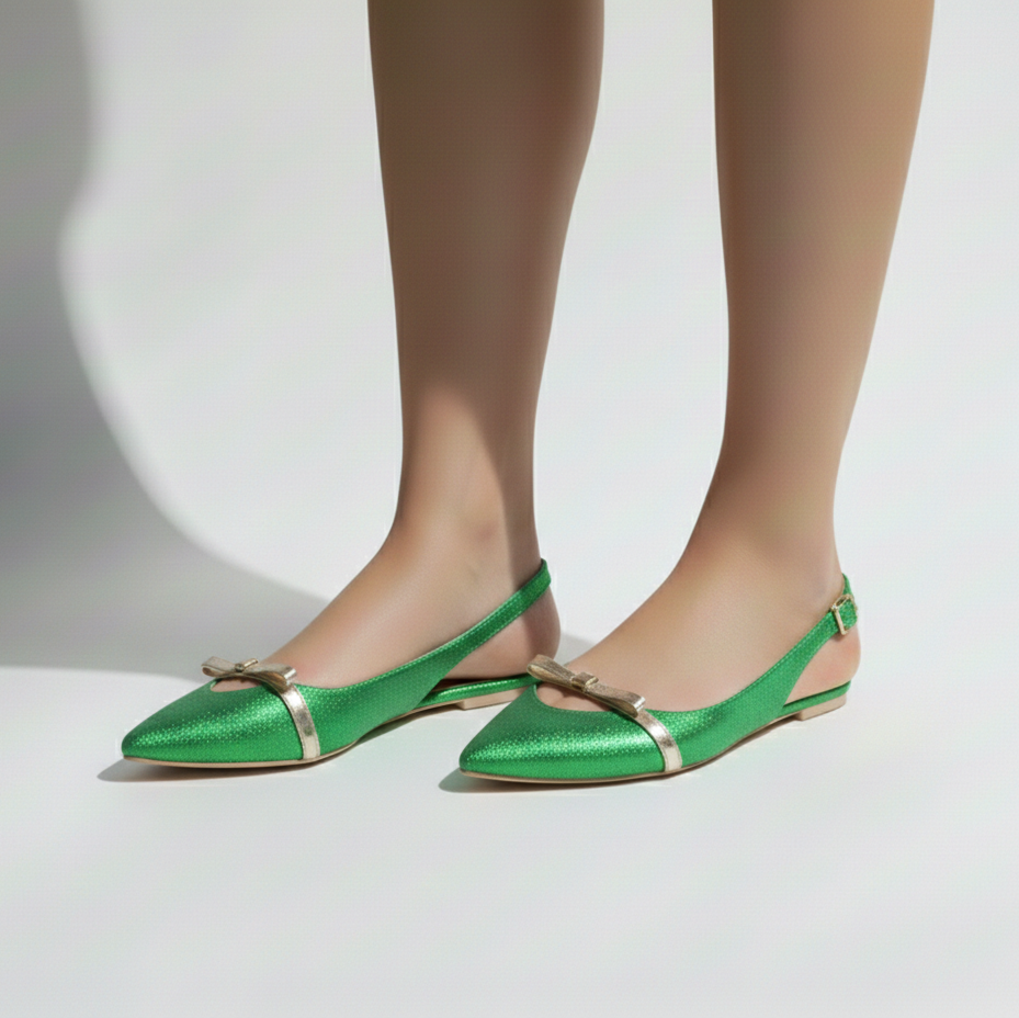 Green shoes with gold accents worn by a person on a white background