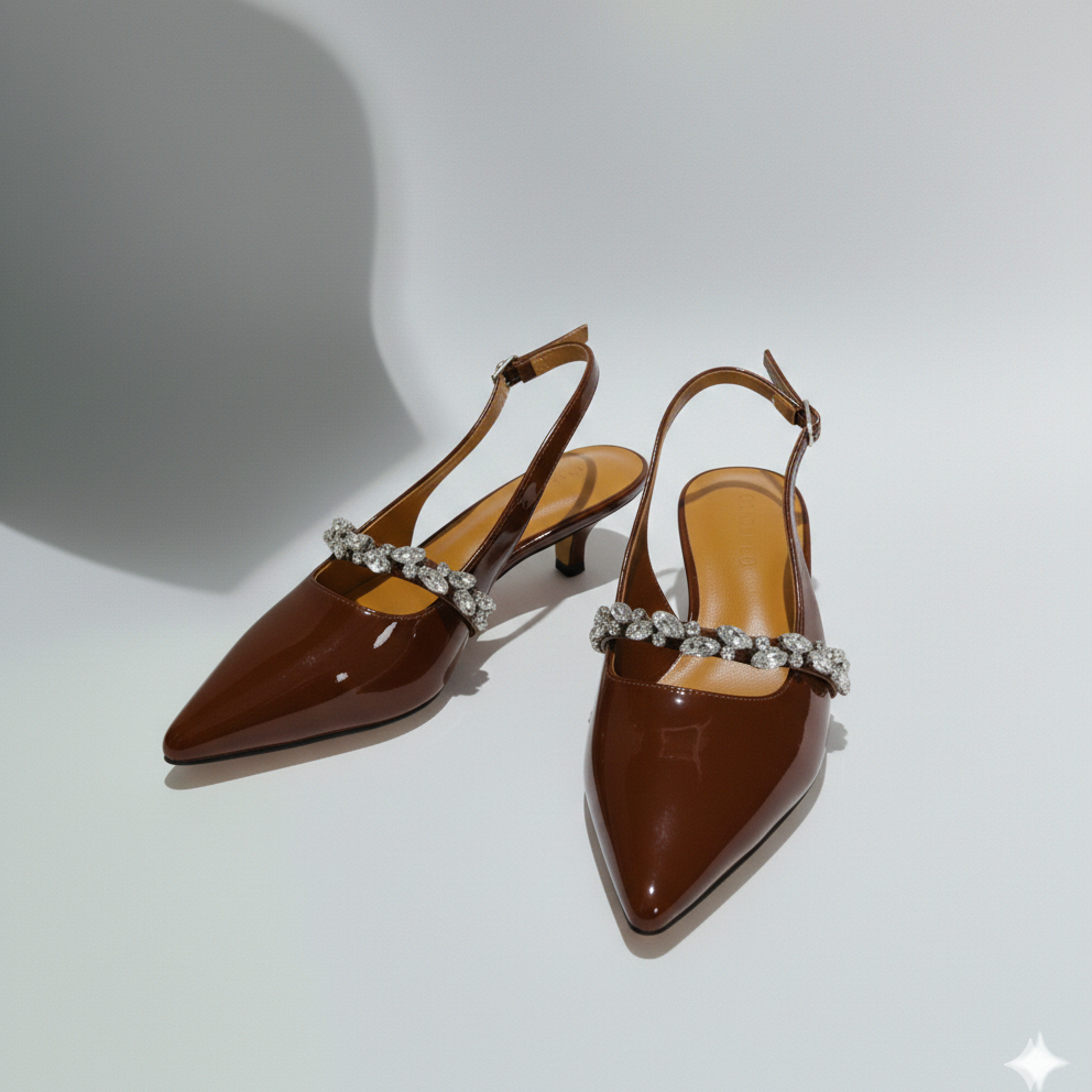 Brown high-heeled shoes with embellished straps on a white background